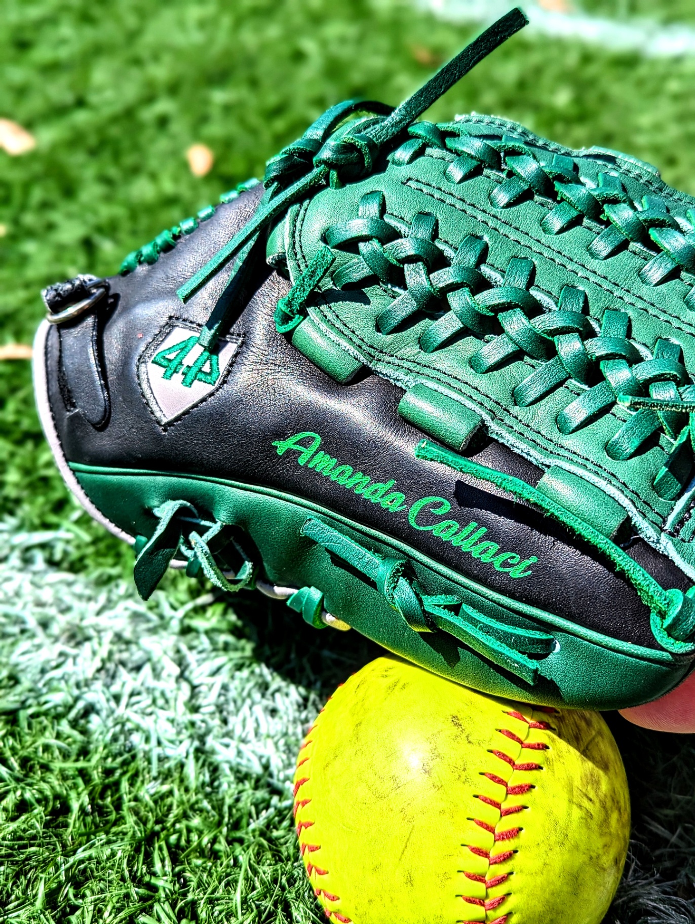 Neon green script name engraved on black 44 Pro softball glove