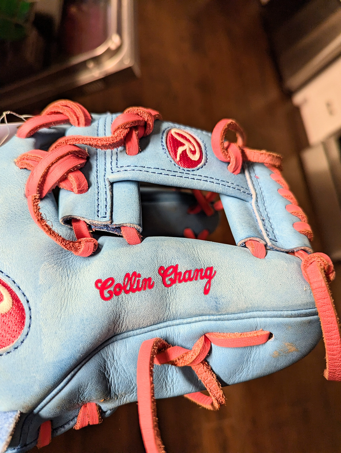 Pink cursive name color-fill engraved on Columbia blue Rawlings Heart of the Hide infield glove