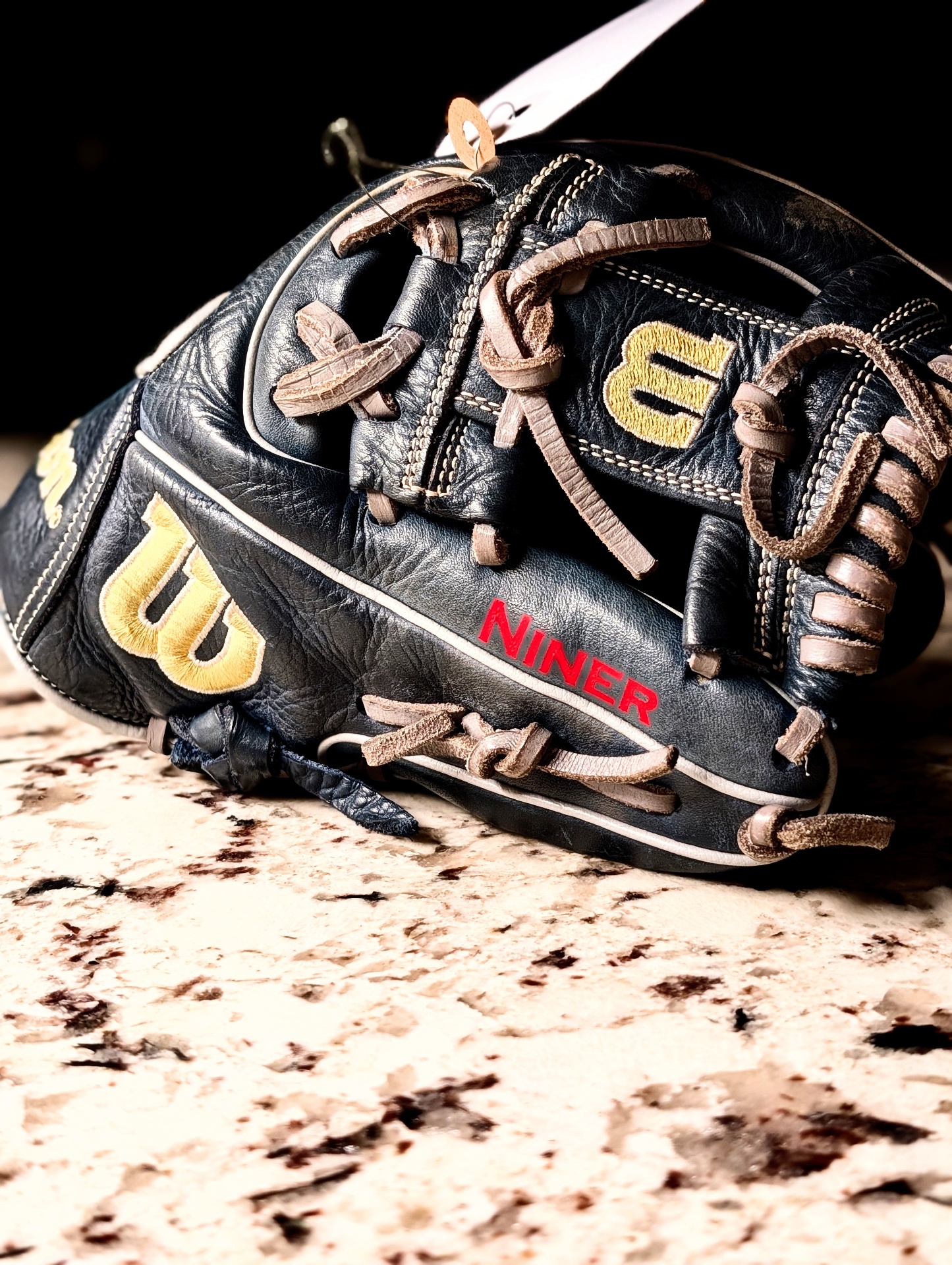 Red Copperplate font name engraved on Wilson A1000 baseball glove